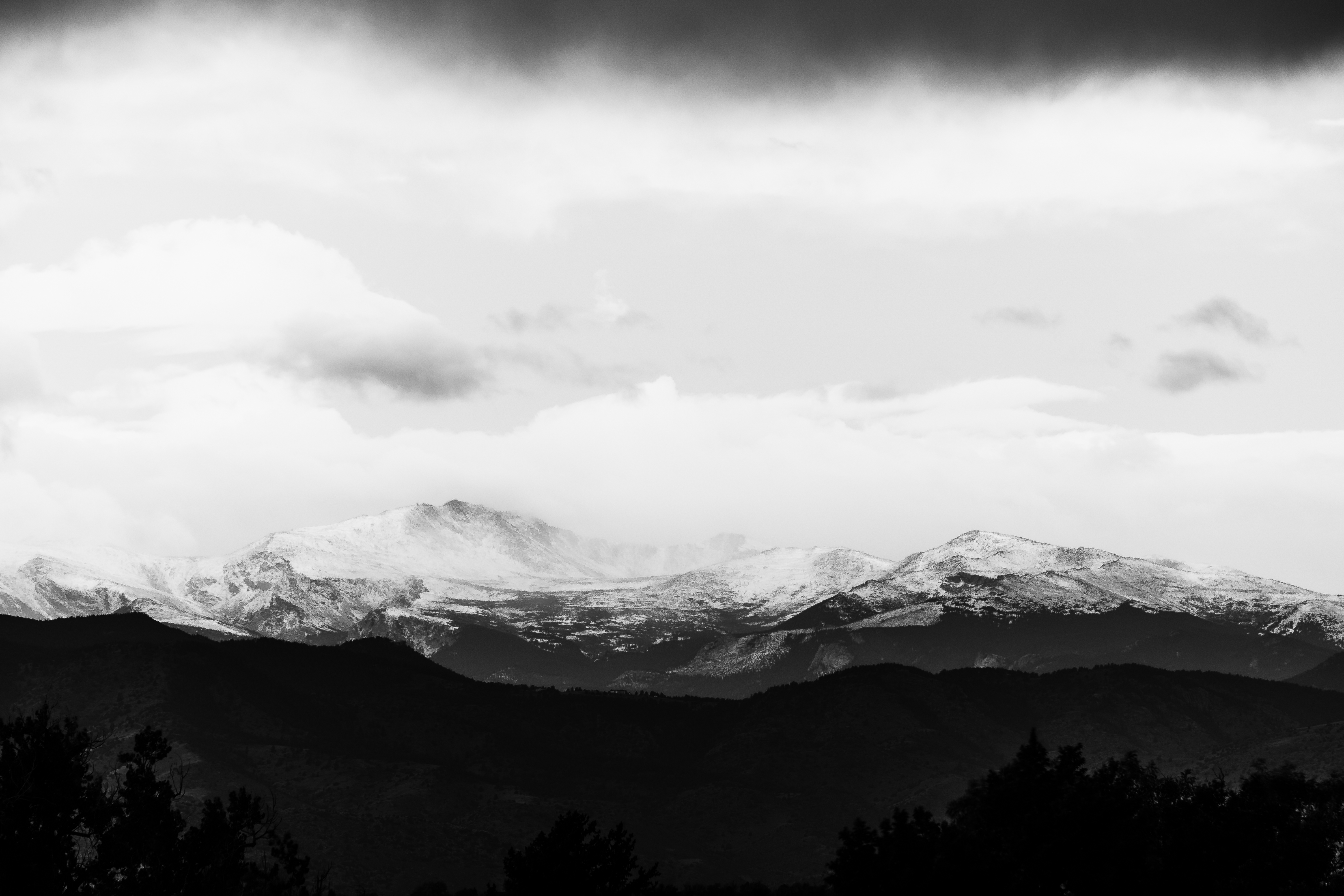 Black and white mountain range with stormy clouds